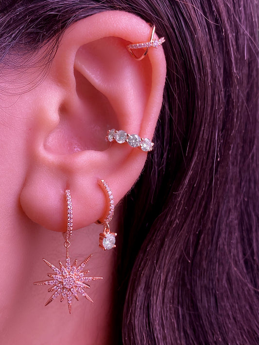Dangling star earrings.