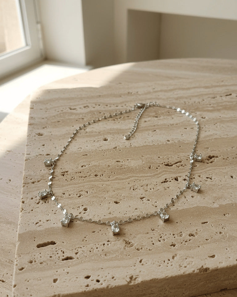 mirror link chain with dangling CZ oval shape stones.