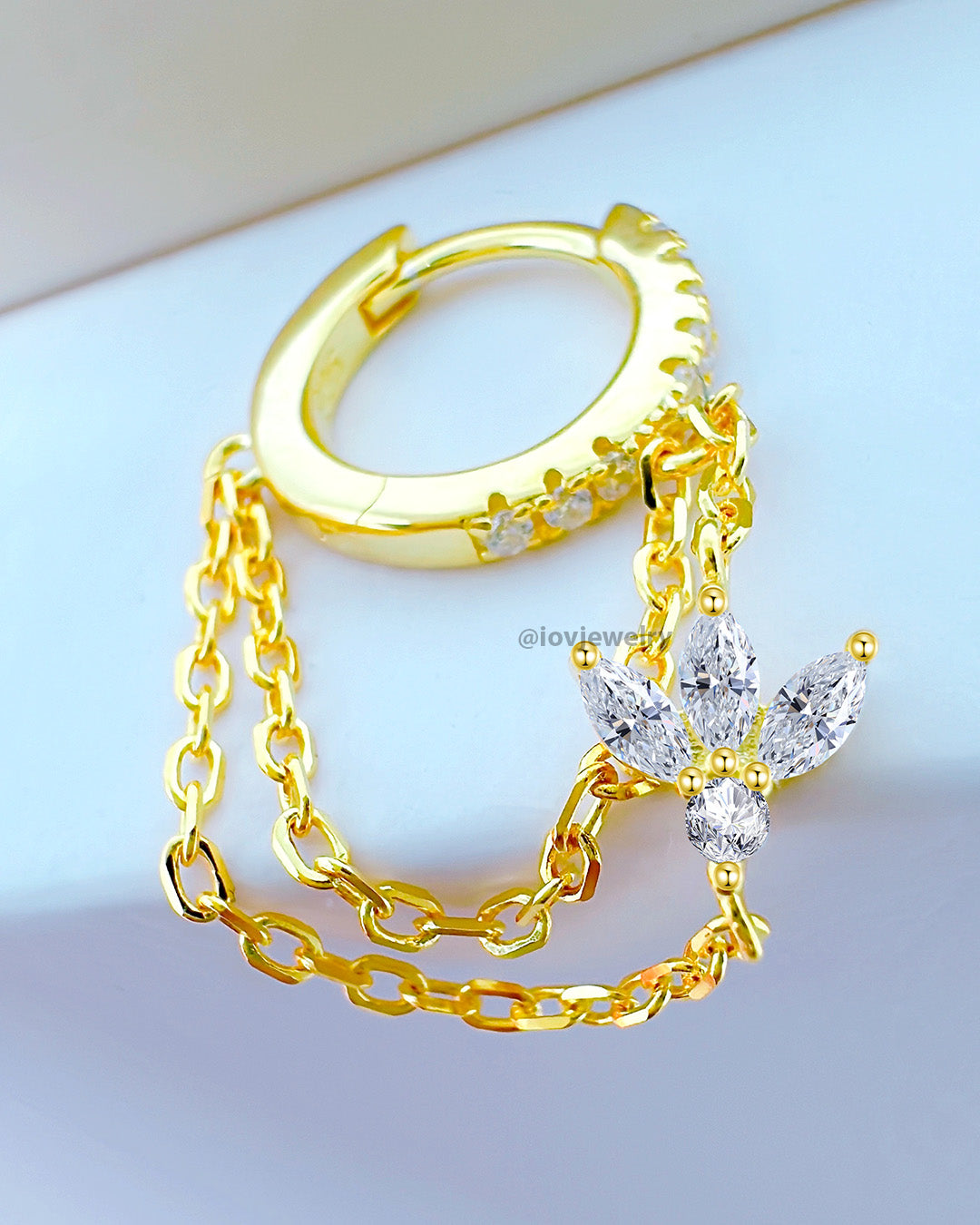 CZ huggie hoop with dangling double chains adorned with louts shape marquise stones.