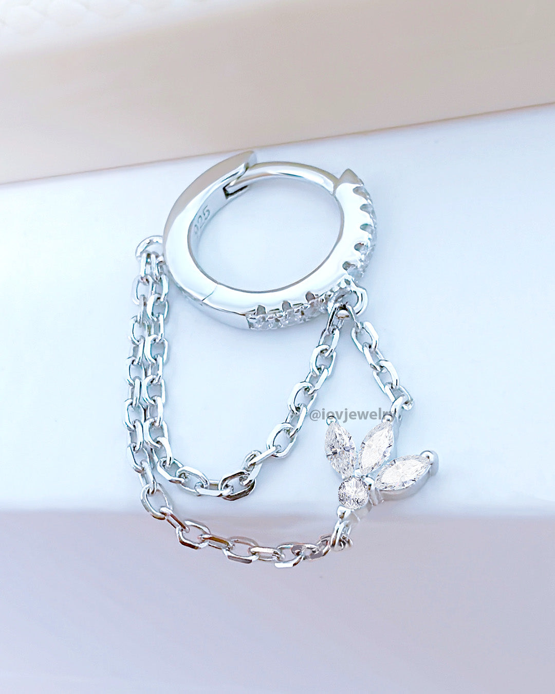 CZ huggie hoop with dangling double chains adorned with louts shape marquise stones.