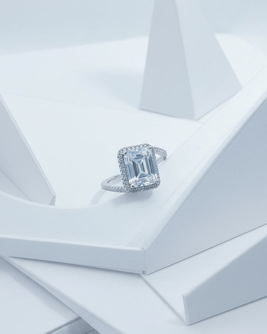 CZ emerald cut in halo setting solitaire ring.