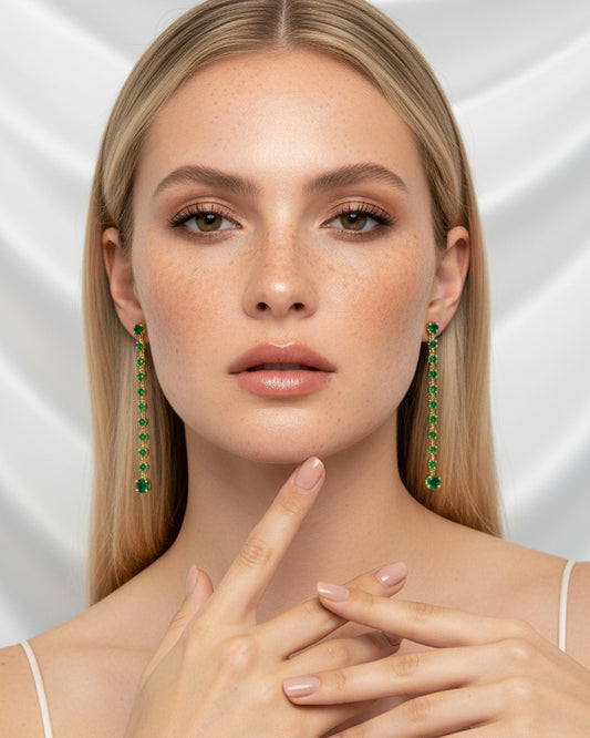 long line of emerald color round stones stud earring.