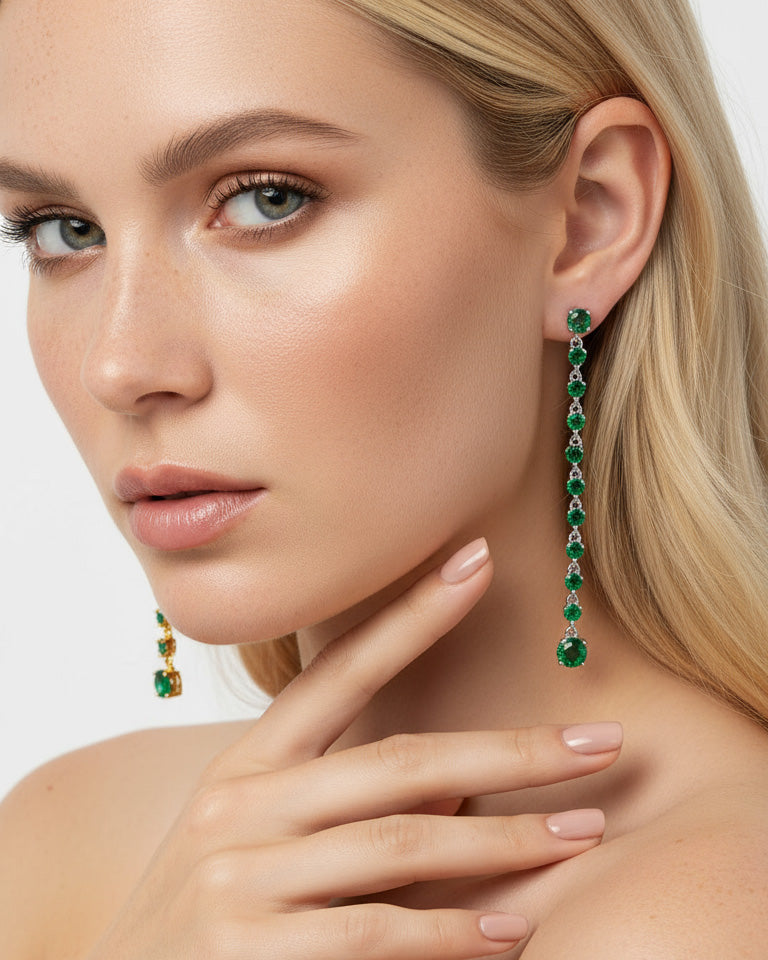 long line of emerald color round stones stud earring.