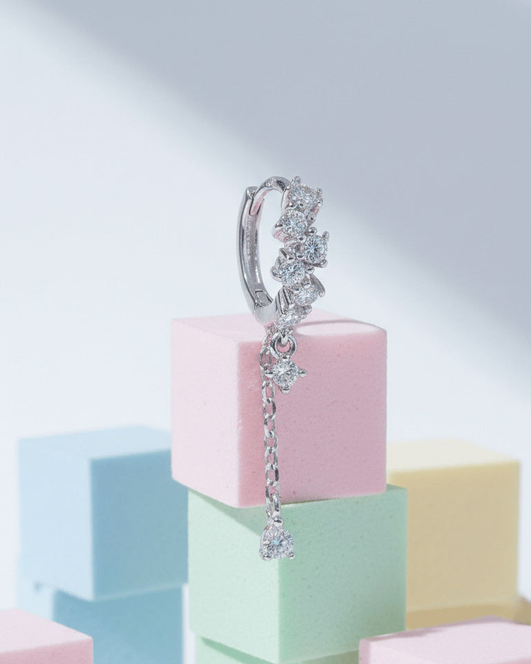 uneven Round CZ arrangement huggie hoop with dangling double chain.