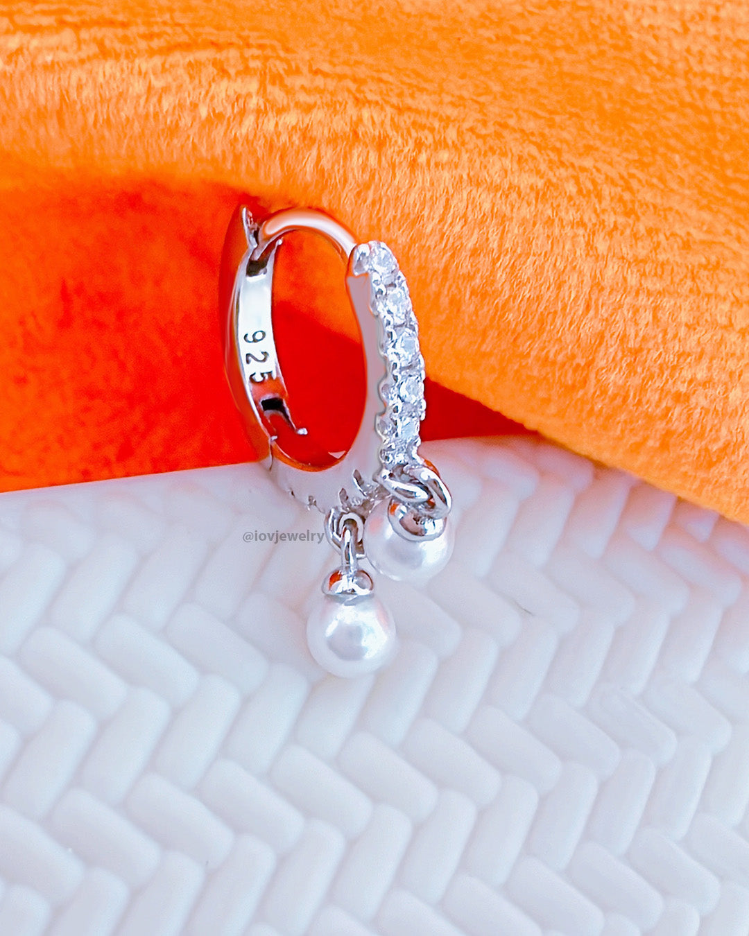CZ huggie hoop earring with dangling two pearls.