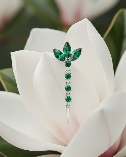 lotus shape stud earring with dangling line of emerald color stones.