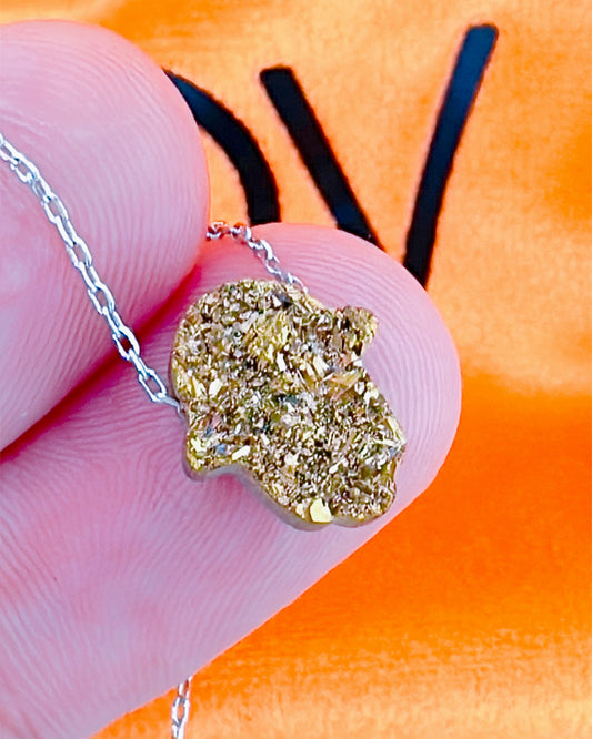 Hamsa shape movable stone multi faceted golden color necklace.