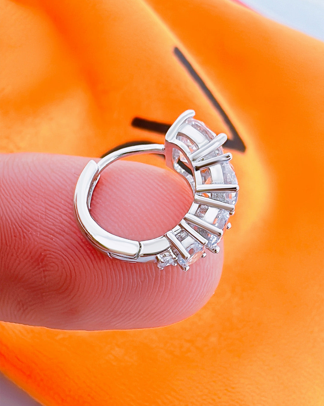 huggie hoop earring with graduated round CZ stones.