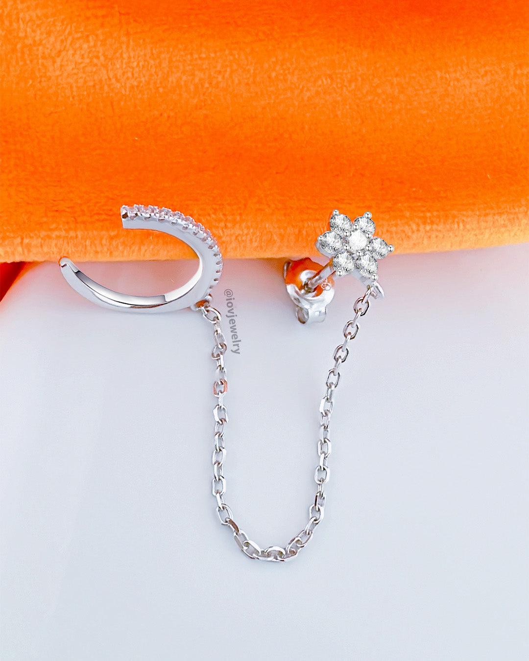 CZ flower shape cluster setting stud earring chain-linked to earcuff.