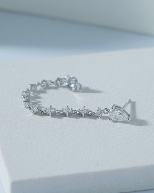back to front pear shape stud with dangling CZ chain earring.