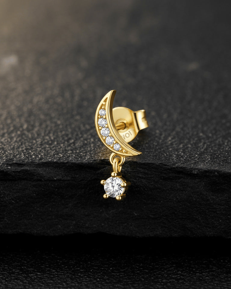 crescent shape with dangling round stone.