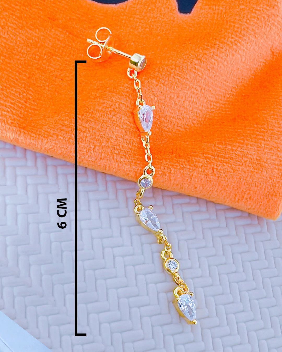 CZ long earring with round and pear shape stones.