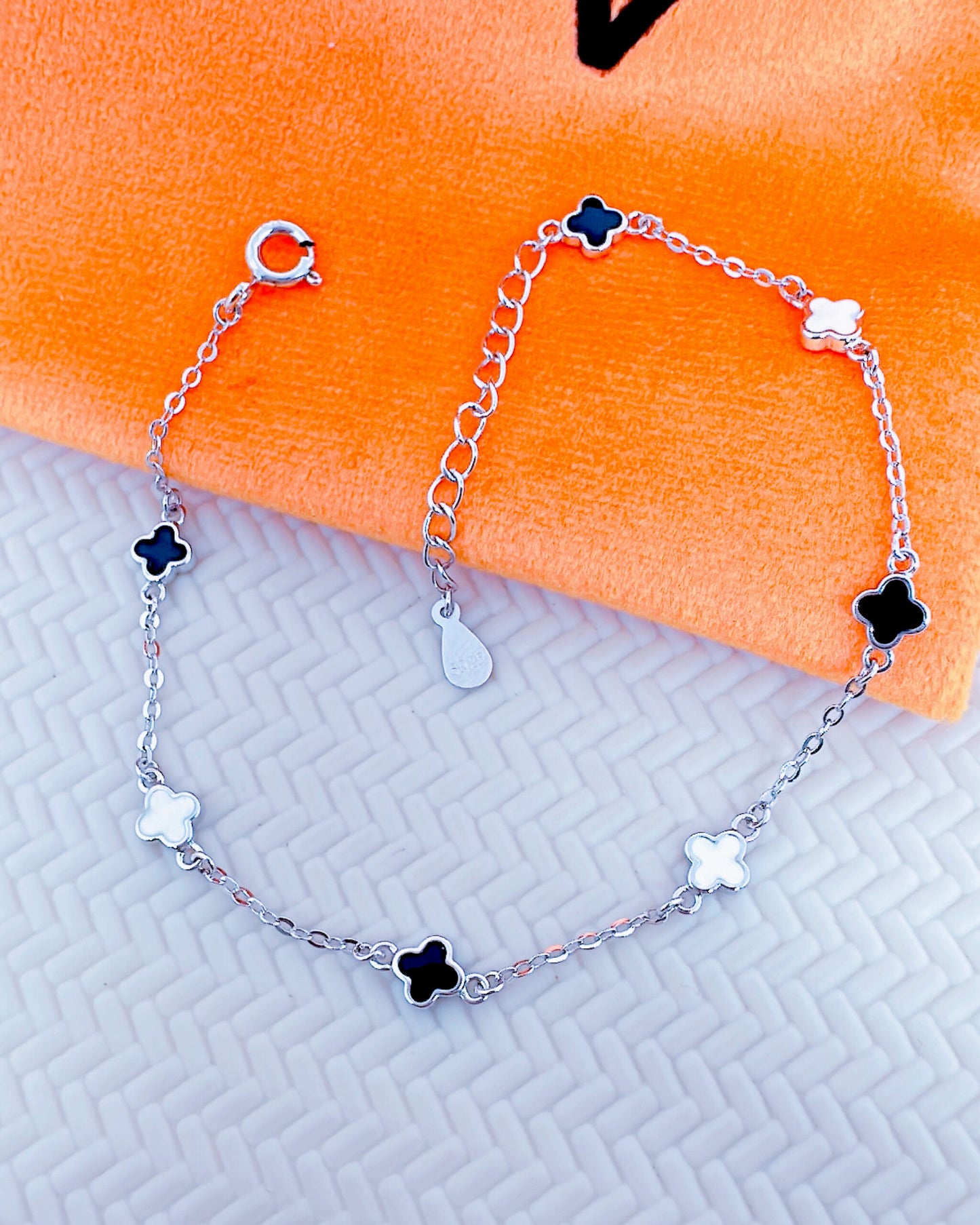 black and white four clover shape bracelet.