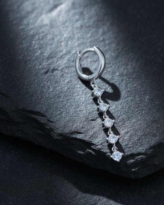 plain huggie hoop with five dangling white CZ.
