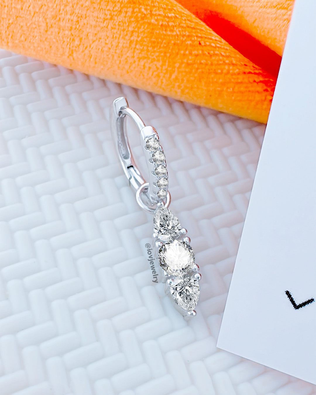 CZ huggie hoop earring with removable line of pear and round shape stones.