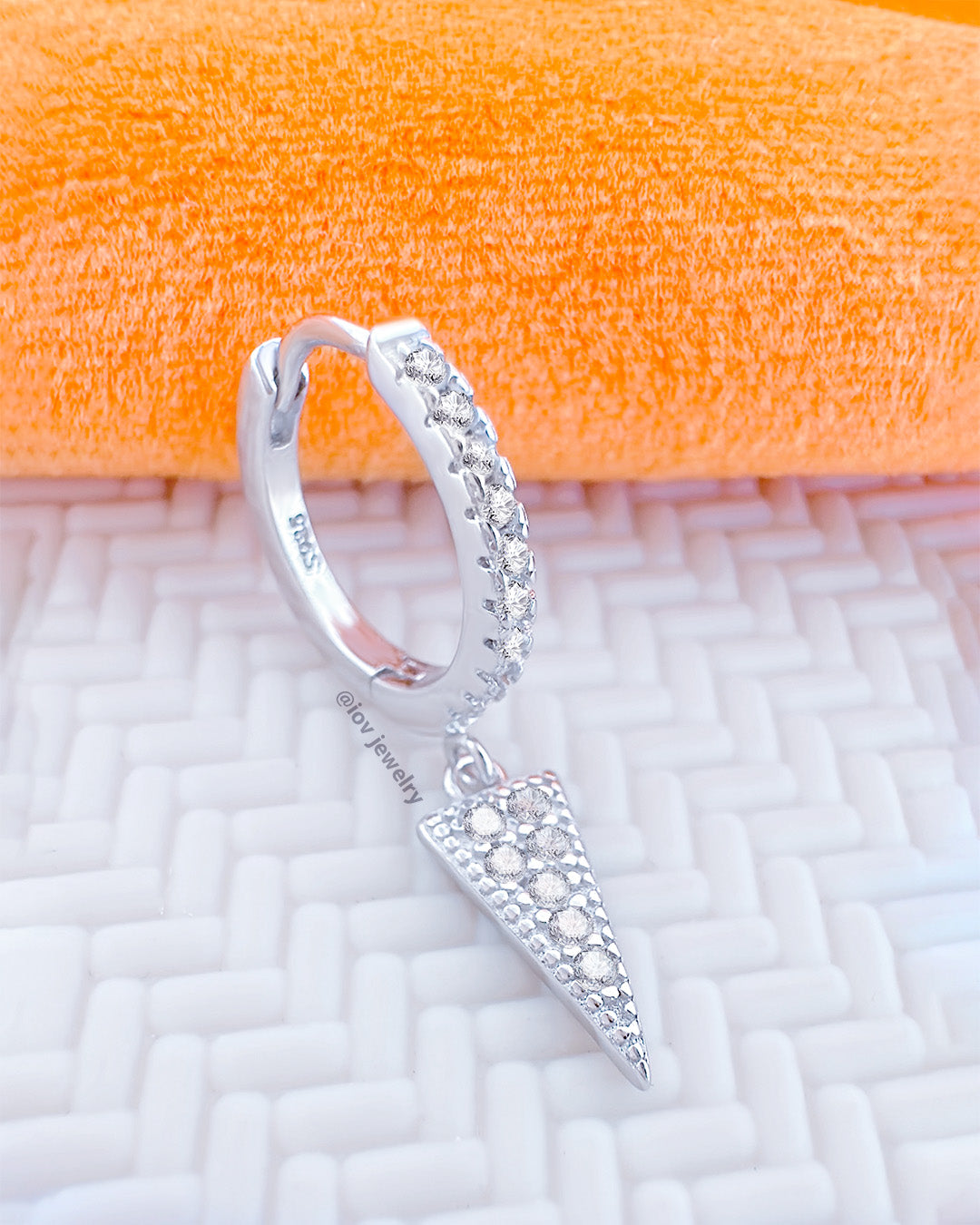 CZ huggie hoop with dangling triangle shape.