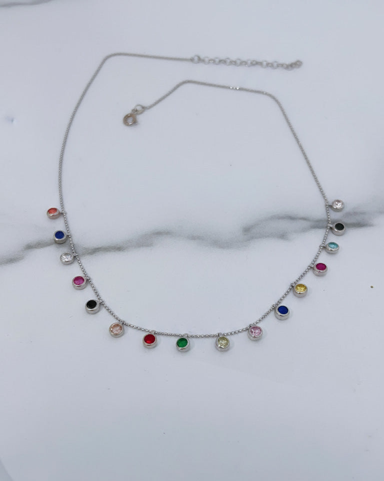 fine necklace with colored dangling CZ in bezel setting.