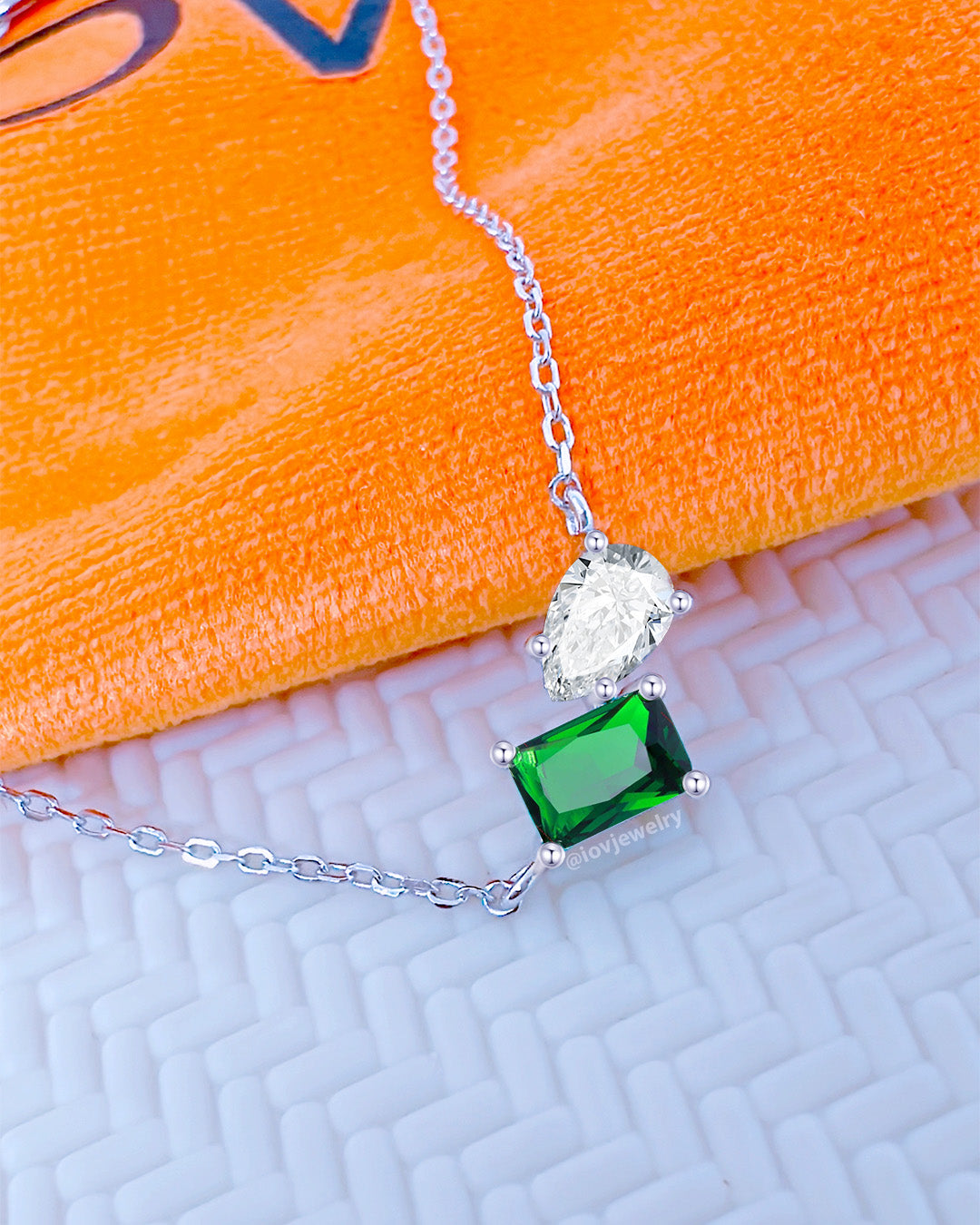 emerald color rectangular and white pear shape toi et moi model necklace.