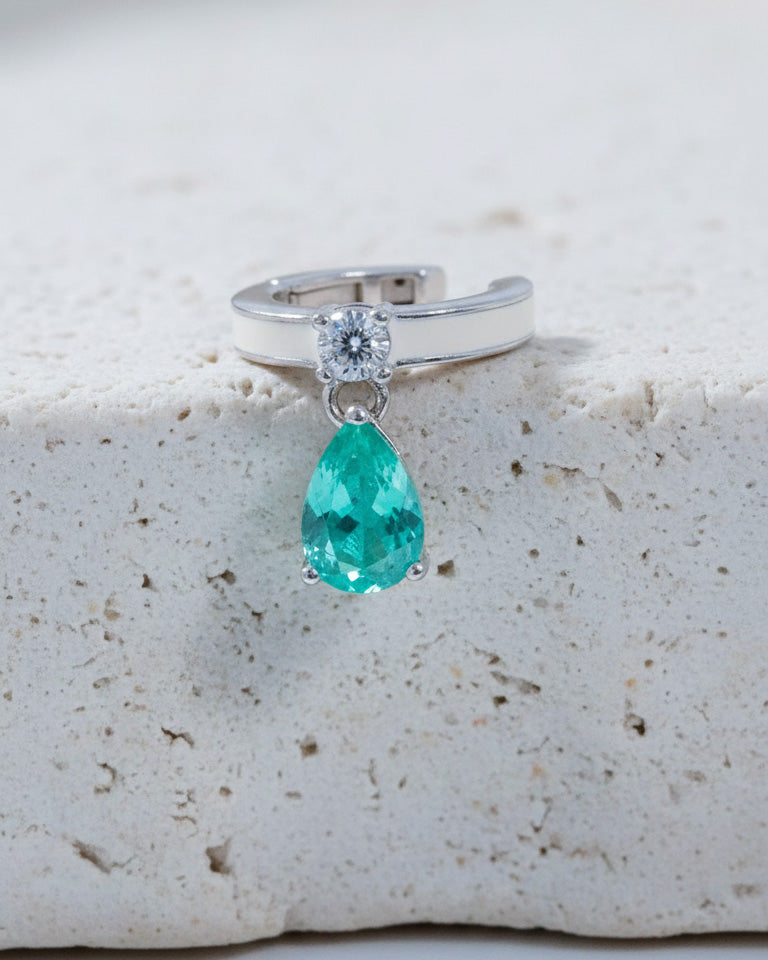 white enamel ear-cuff with dangling green pear shape CZ stone.
