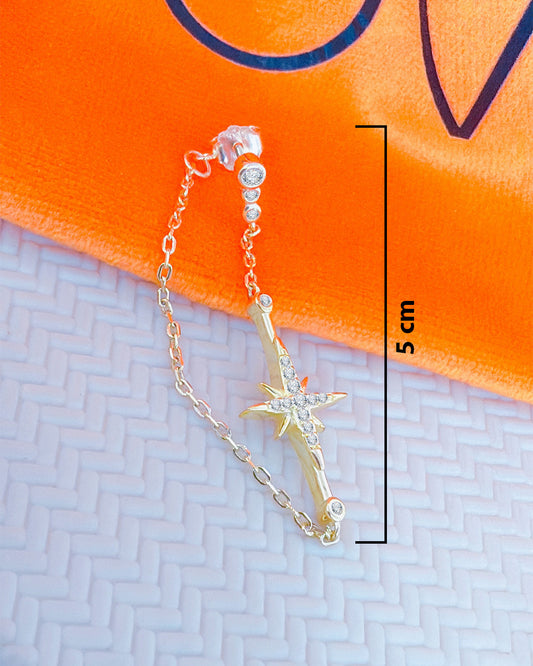 back to front chain earring with dangling star.