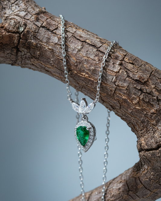 Emerald color pear shape with three white marquise shapes necklace.