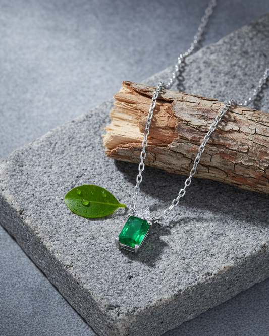 emerlad cut green CZ stone with three white stones neckace.