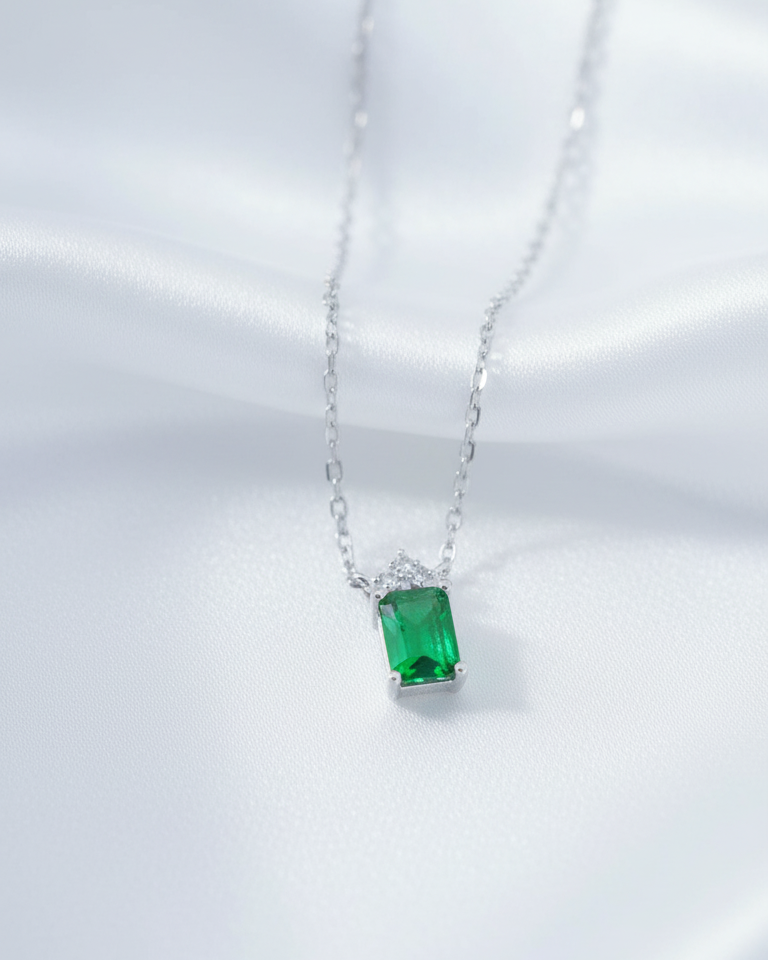 emerlad cut green CZ stone with three white stones neckace.