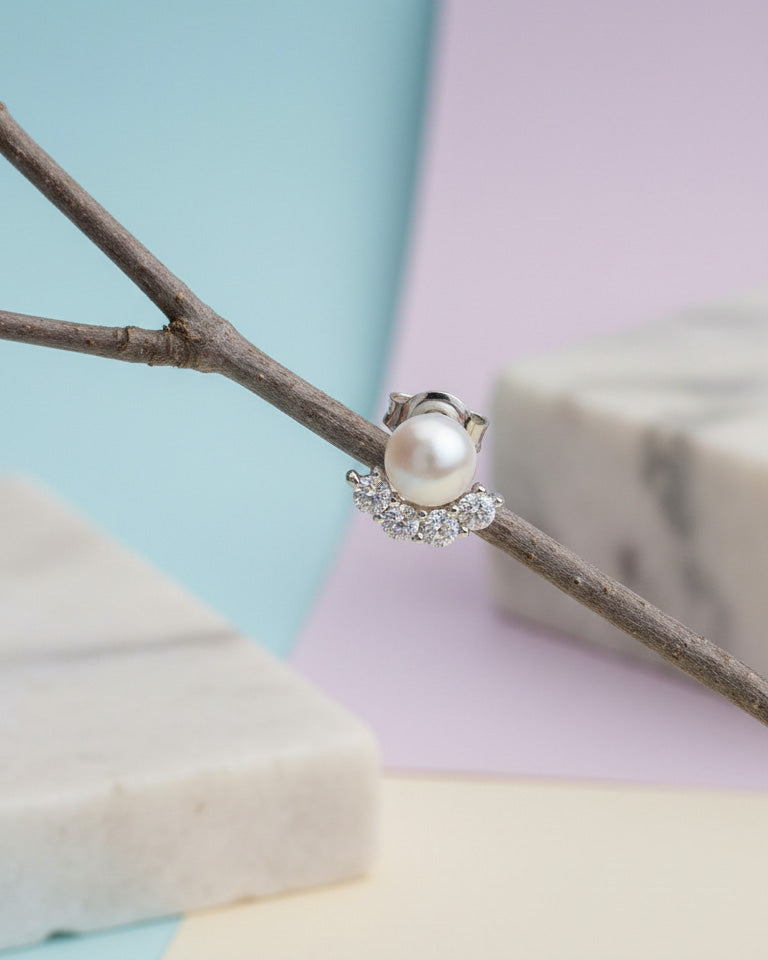 Pearl stud earring with four round CZ stones.