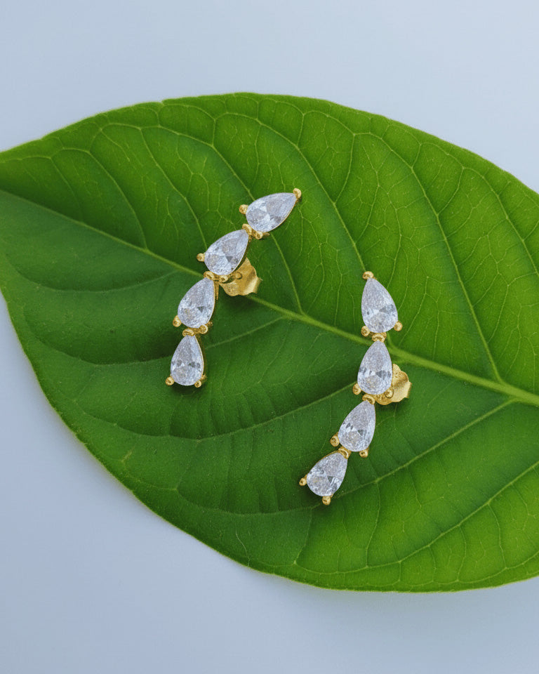 curved bar of four pear shape stones stud earring.