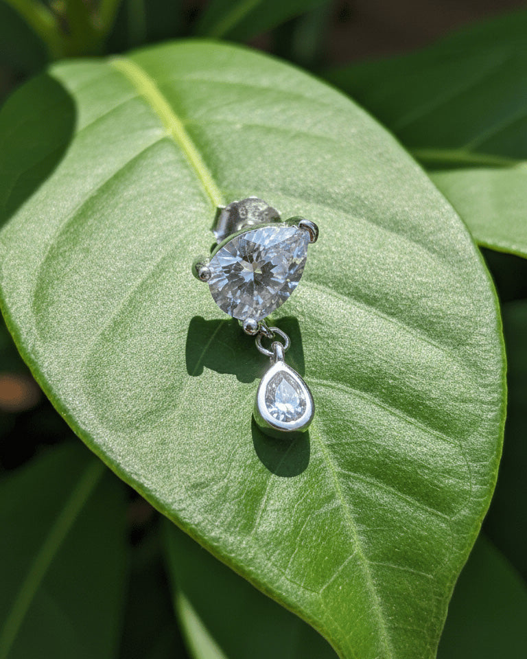 pear shape in prong setting with a dangling smaller pear in bezel setting stud earring.