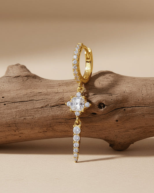 CZ luxury hoop earring with dangling rectangular stone and graduated round stones.