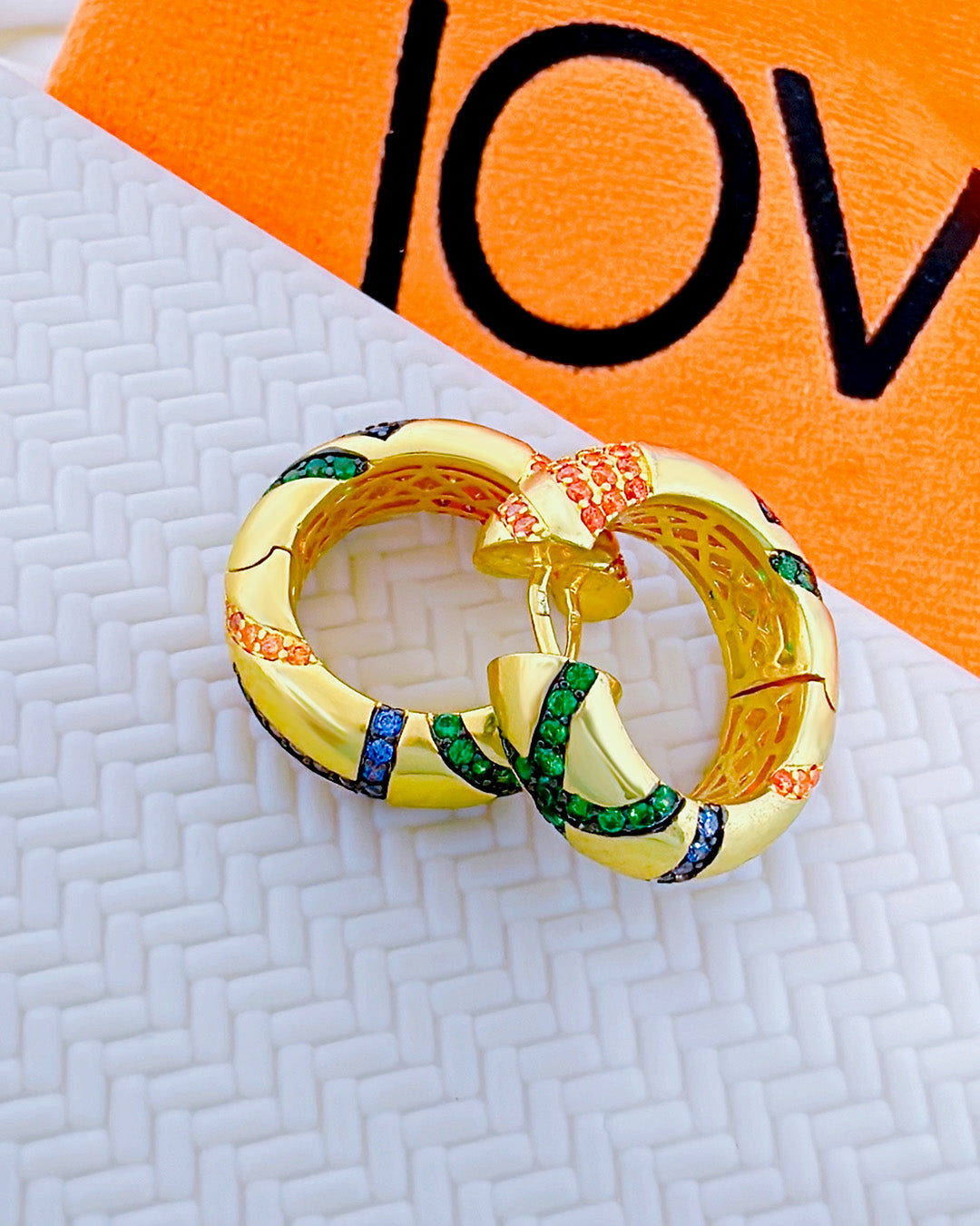 chunky wide hoop earring studded with colorful CZ.