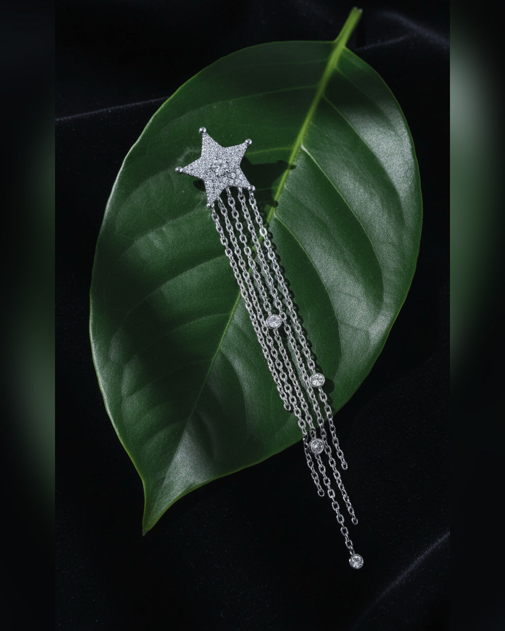 Star stud earring with long dangling chains.
