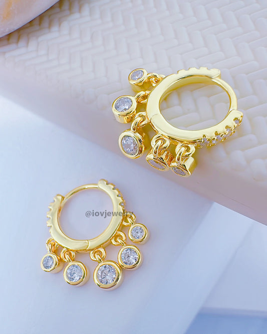 9mm huggie hoop earring with dangling CZ stones in bezel setting.