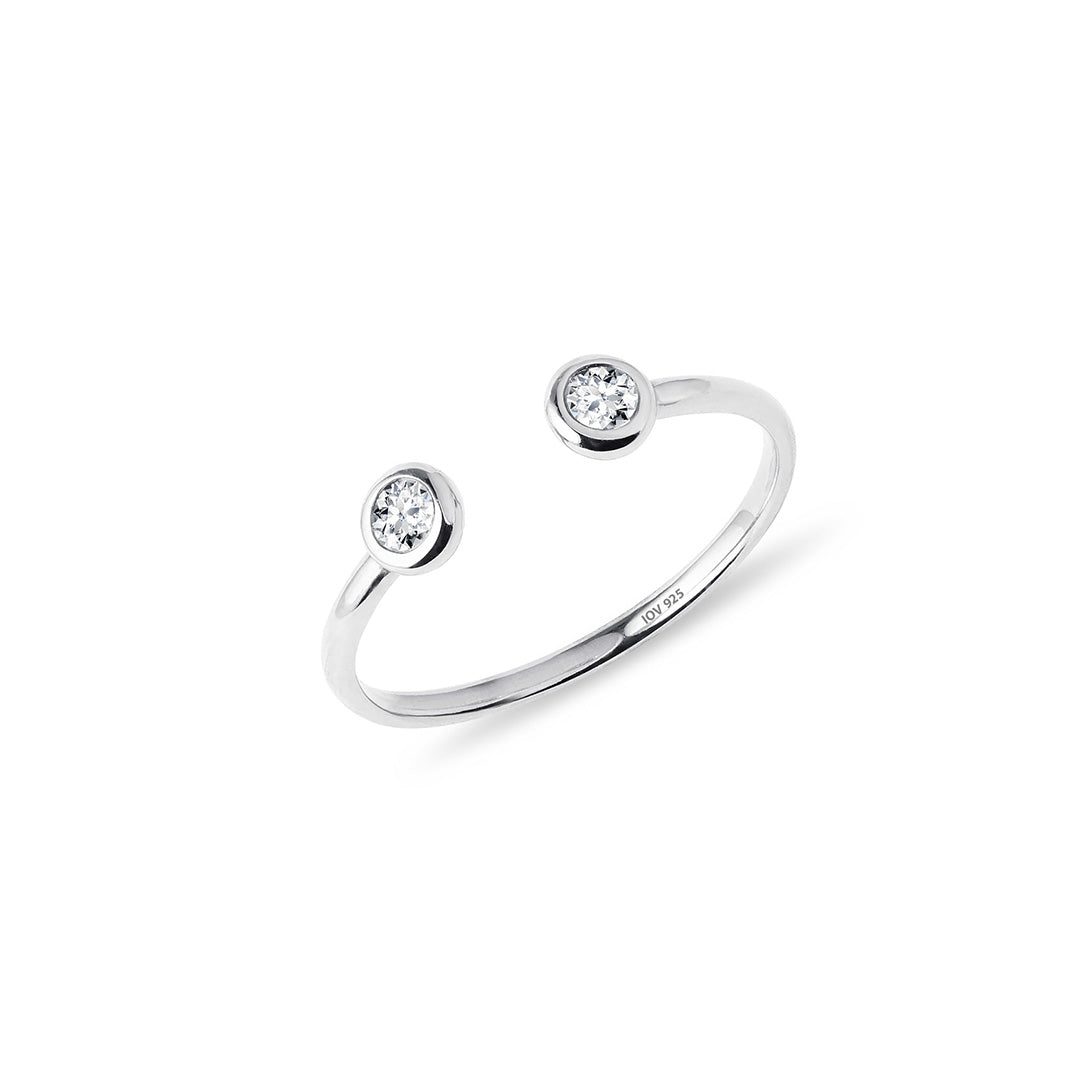 Open adjustable ring with two bezel stones.
