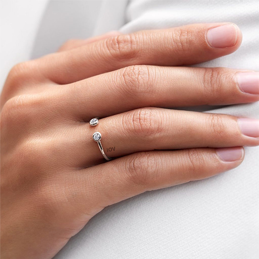 Open adjustable ring with two bezel stones.