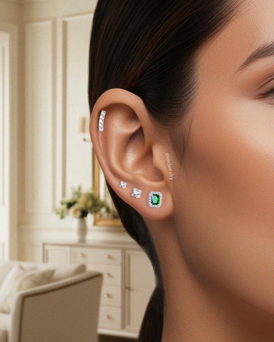 CZ emerald color rectangular stone in a halo setting stud earring.