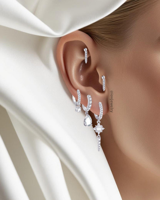 CZ luxury hoop earring with dangling rectangular stone and graduated round stones.