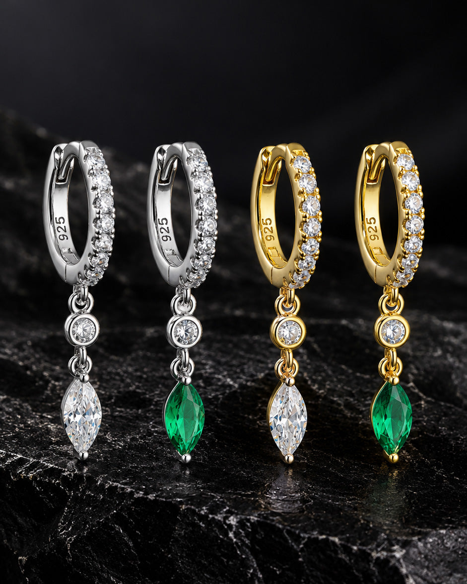 CZ huggie hoop with dangling white and emerald color stones.