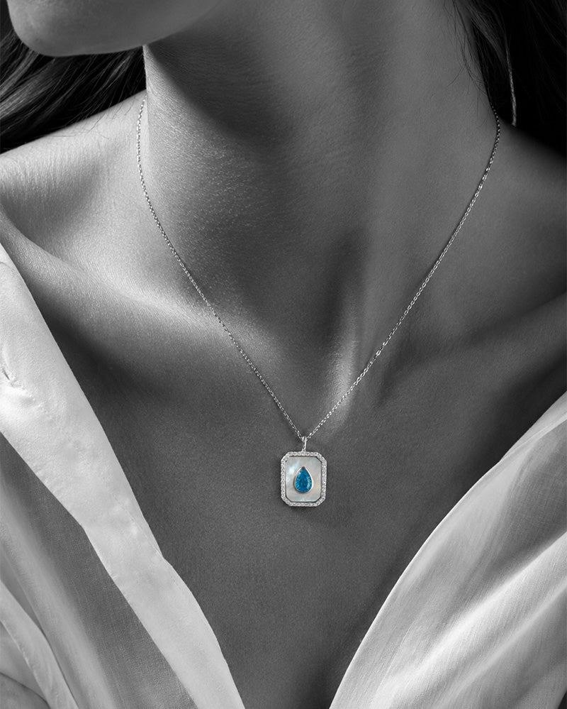 rectangular MOP necklace with pear shape aquamarine color CZ stone.