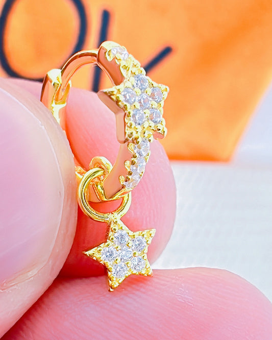 CZ huggie star hoop with dangling star shape.