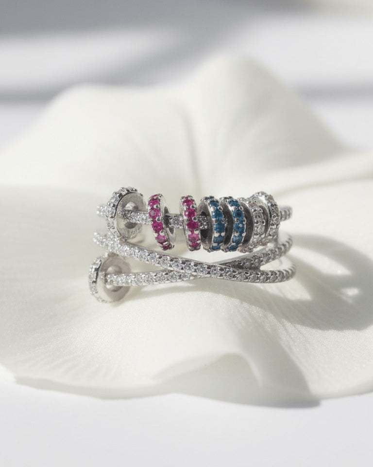 X shape ring with movable links of colored CZ.
