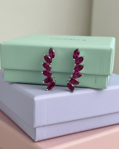 Climber style emerald and ruby color earrings.