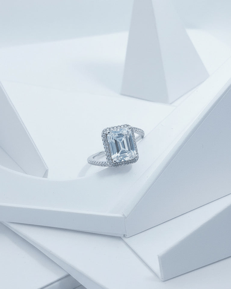 CZ emerald cut in halo setting solitaire ring.