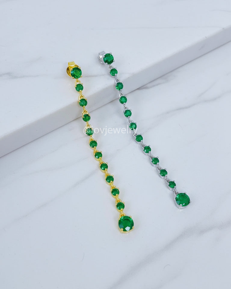 long line of emerald color round stones stud earring.