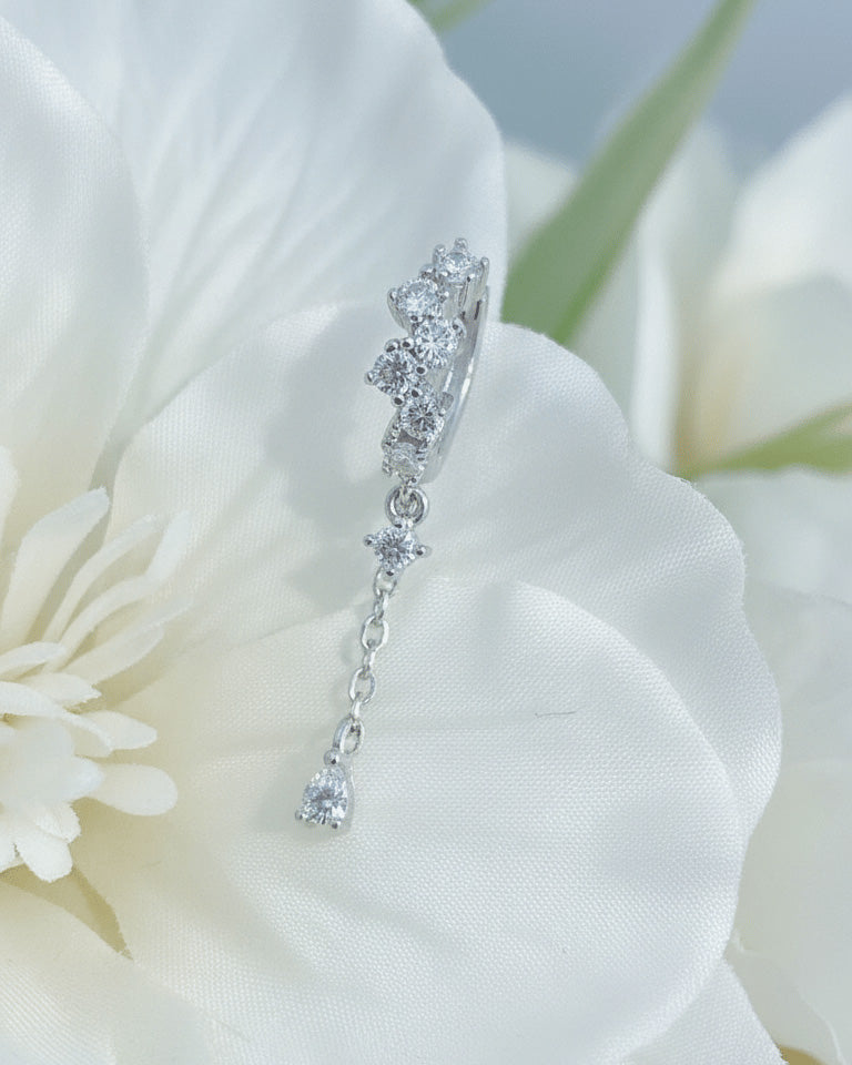 uneven Round CZ arrangement huggie hoop with dangling double chain.
