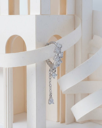 uneven Round CZ arrangement huggie hoop with dangling double chain.