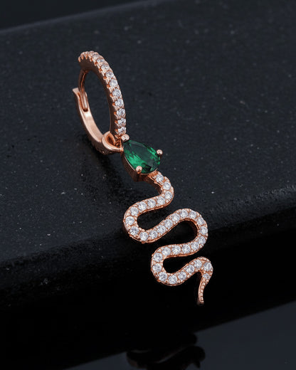 huggie hoop with dangling snake shape plated with rose gold.