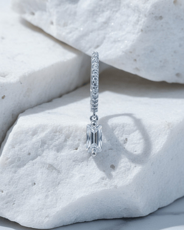 10 mm CZ hoop with dangling rectangular baguette shape stone.
