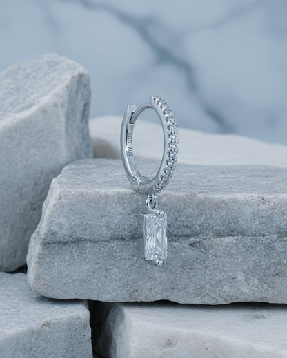 10 mm CZ hoop with dangling rectangular baguette shape stone.